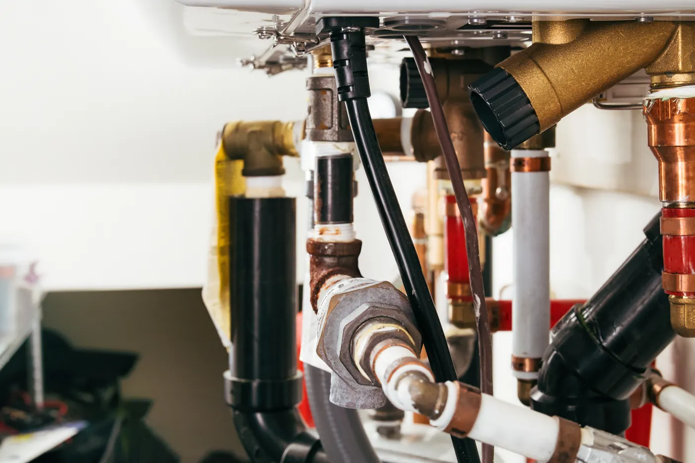 Copper and brass piping beneath a residential hydronic boiler heating system